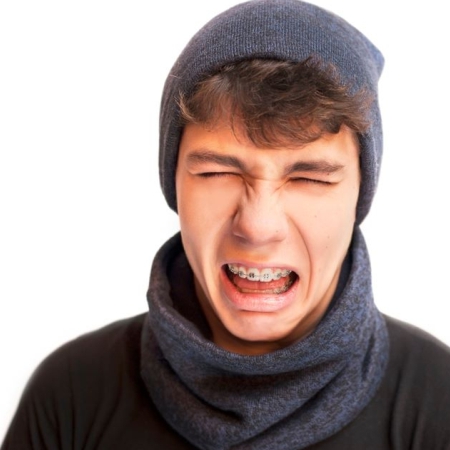 Teen experiencing braces-related discomfort and irritation