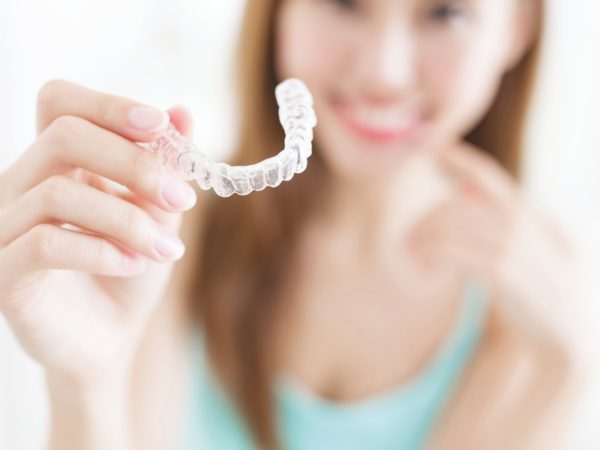 Patient holding a transparent clear aligner tray