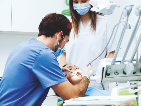 Orthodontist performing a dental assessment before aligner treatment
